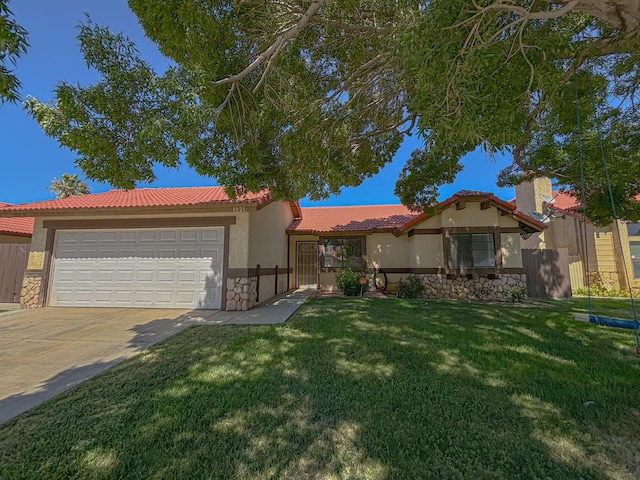 view of front of home with a front yard and a garage