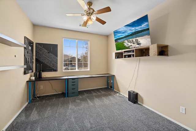 unfurnished office with baseboards, visible vents, ceiling fan, and carpet