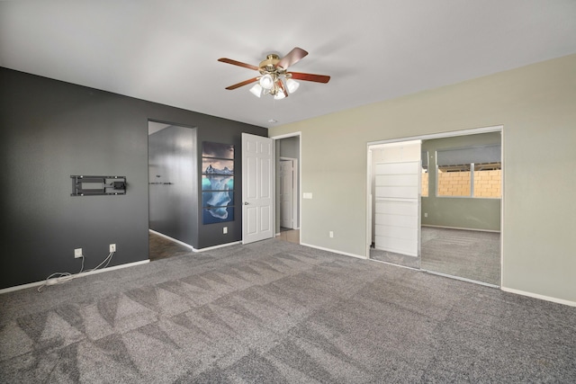 unfurnished bedroom featuring baseboards, carpet flooring, and a ceiling fan