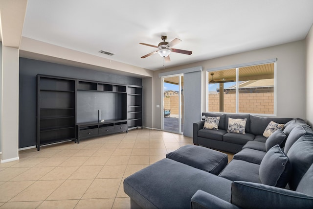 living area featuring a ceiling fan, light tile patterned floors, baseboards, and visible vents