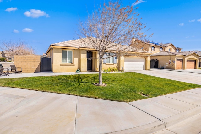 view of front facade with concrete driveway, stucco siding, a gate, a front lawn, and a garage