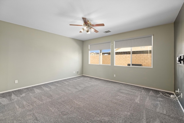 unfurnished room featuring baseboards, carpet flooring, ceiling fan, and visible vents