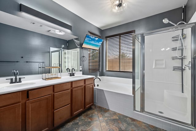 full bath with a sink, a bath, and a shower stall