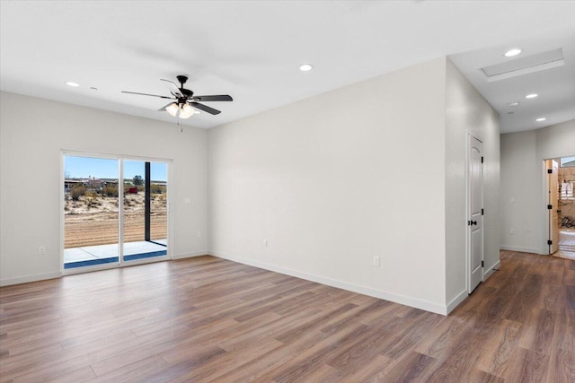 unfurnished room featuring ceiling fan, recessed lighting, wood finished floors, and baseboards