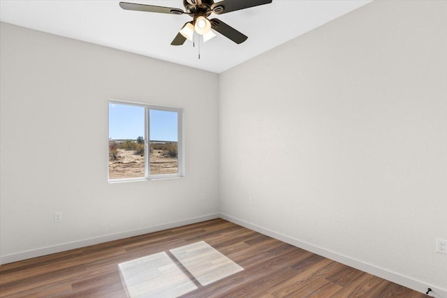 spare room featuring a ceiling fan, baseboards, and wood finished floors