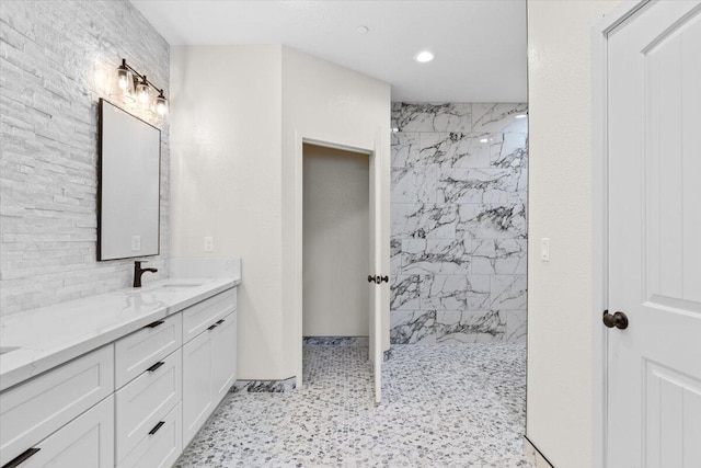 full bathroom with recessed lighting, vanity, and a marble finish shower