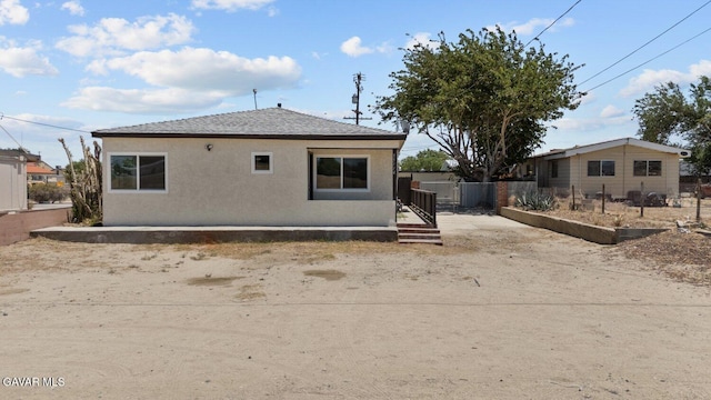 35114 E 82nd St Unit E, Littlerock, CA 93543 - rear view of house with stucco siding and roof with shingles