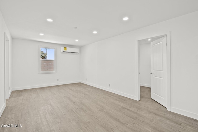 35114 E 82nd St Unit E, Littlerock, CA 93543 - unfurnished room with an AC wall unit, light wood-style flooring, and recessed lighting