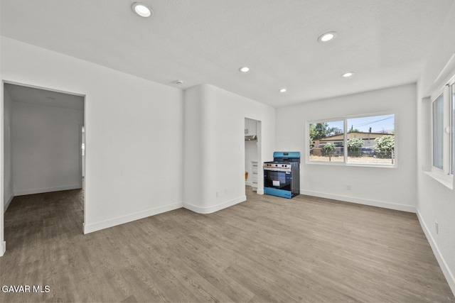 35114 E 82nd St Unit E, Littlerock, CA 93543 - unfurnished living room featuring recessed lighting and wood finished floors