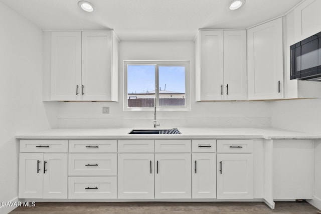 35114 E 82nd St Unit E, Littlerock, CA 93543 - kitchen with white cabinets, black microwave, recessed lighting, and wood finished floors