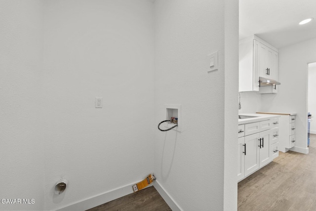 35114 E 82nd St Unit E, Littlerock, CA 93543 - laundry room with hookup for a washing machine, cabinet space, and light wood finished floors