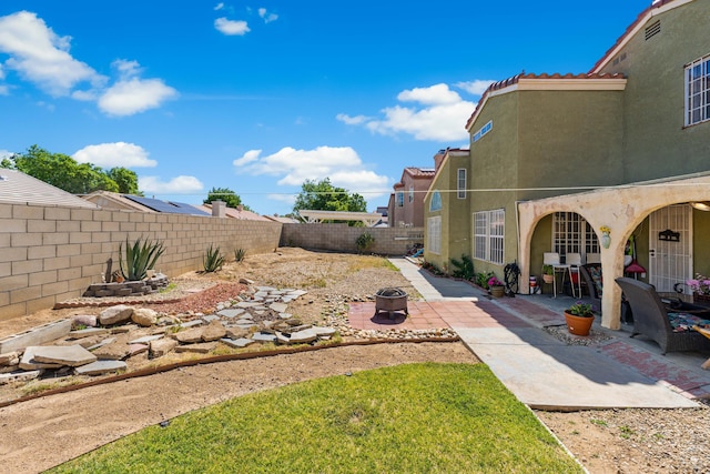 2321 Mulberry Ave, Lancaster, CA 93535 - fenced backyard featuring a patio and a fire pit