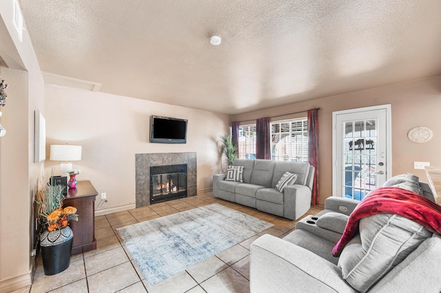 2321 Mulberry Ave, Lancaster, CA 93535 - living room featuring tile patterned floors, a tile fireplace, a textured ceiling, and baseboards