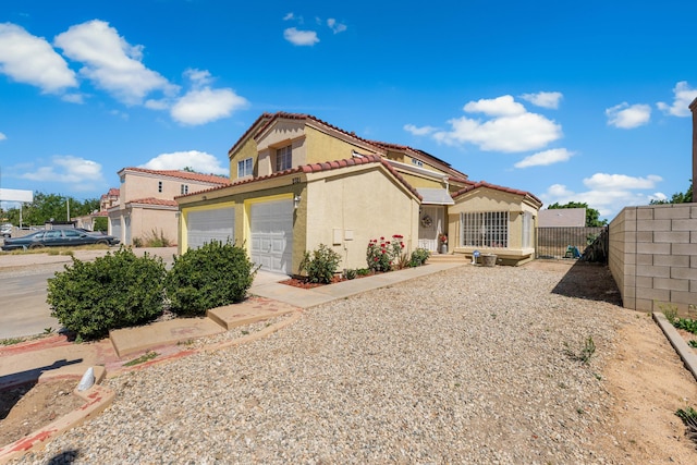 2321 Mulberry Ave, Lancaster, CA 93535 - mediterranean / spanish-style home featuring a tile roof, stucco siding, fence, and a garage