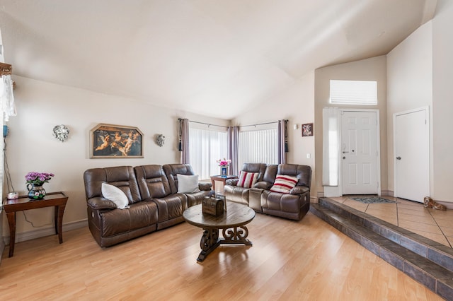 2321 Mulberry Ave, Lancaster, CA 93535 - living area featuring high vaulted ceiling, light wood-style floors, and baseboards