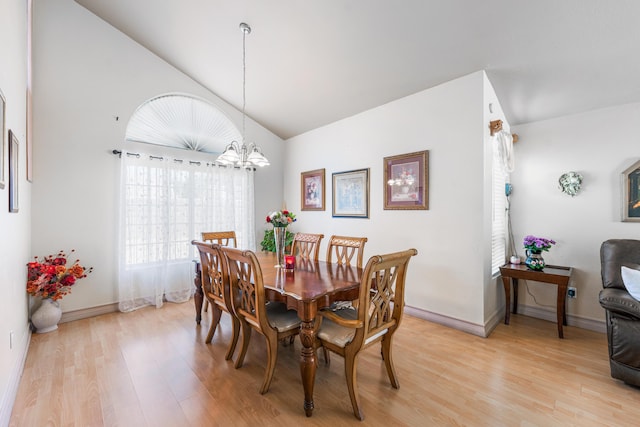 2321 Mulberry Ave, Lancaster, CA 93535 - dining room featuring light wood-type flooring, a chandelier, baseboards, and high vaulted ceiling