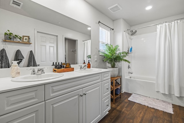 bathroom featuring shower / bath combo, wood-type flooring, and vanity