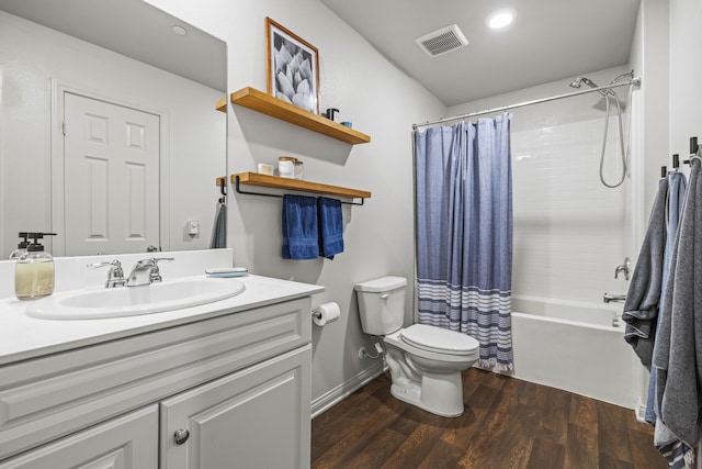 full bathroom with hardwood / wood-style flooring, vanity, toilet, and shower / bath combo with shower curtain