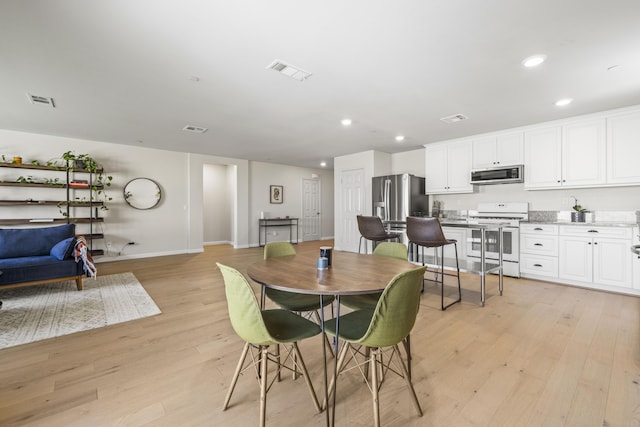 dining area with light hardwood / wood-style floors