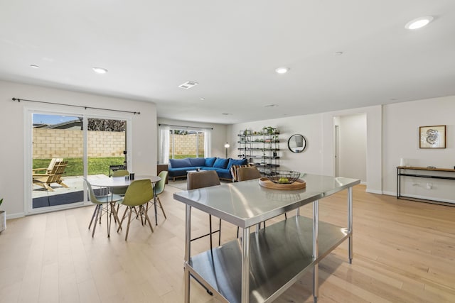 dining room with plenty of natural light and light wood-type flooring