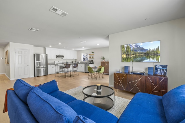 3625 Garnet Ln, Lancaster, CA 93535 - living area with light wood finished floors, recessed lighting, and baseboards