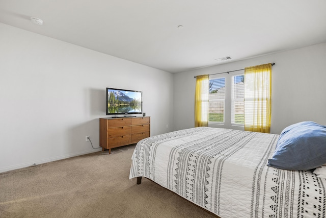 bedroom featuring light colored carpet