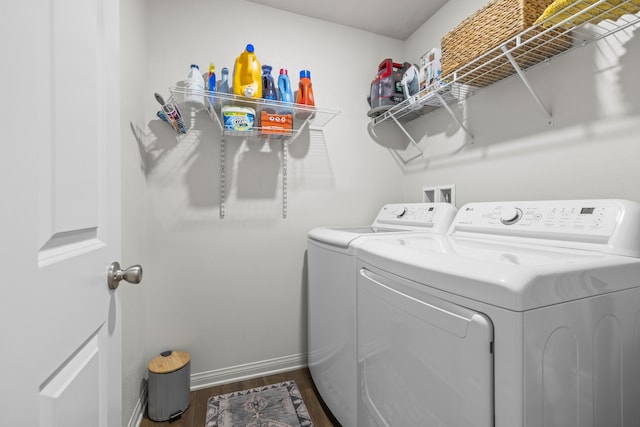 laundry room with dark hardwood / wood-style flooring and independent washer and dryer