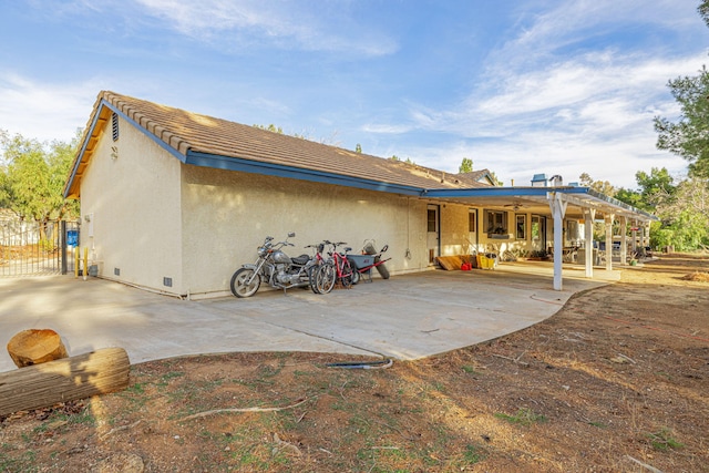 rear view of property featuring a patio area and stucco siding