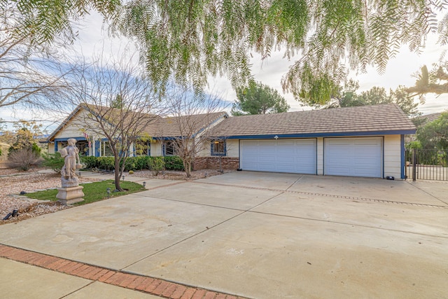 single story home featuring driveway, brick siding, and an attached garage