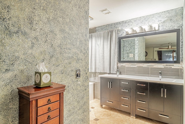 full bath with double vanity, ceiling fan, visible vents, and a sink