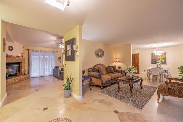 living room featuring a brick fireplace, ceiling fan, and baseboards