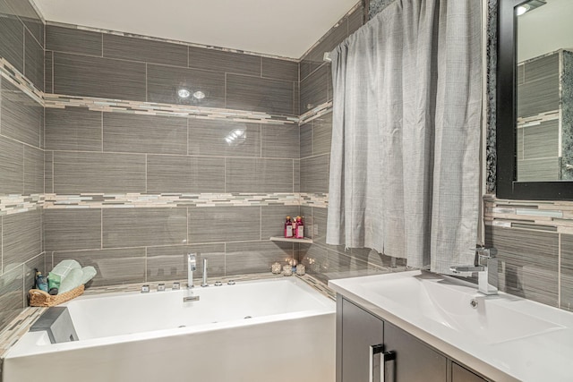 bathroom featuring a garden tub, tile walls, and vanity