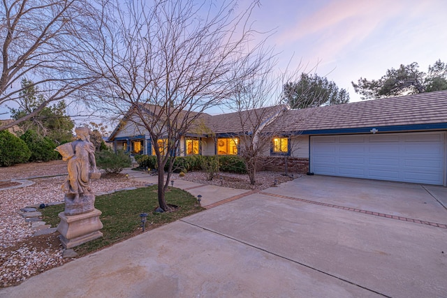 view of front of property with an attached garage and concrete driveway