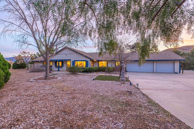 view of front of house with a garage and concrete driveway