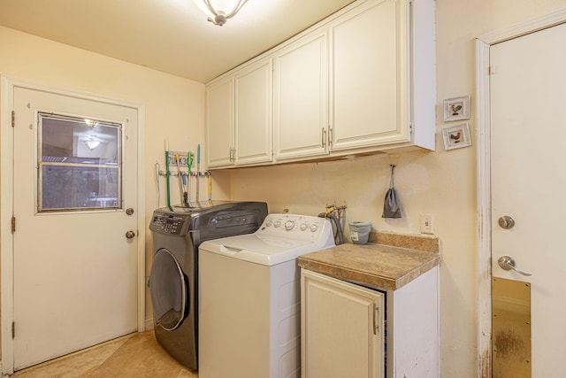 laundry room featuring washing machine and clothes dryer and cabinet space