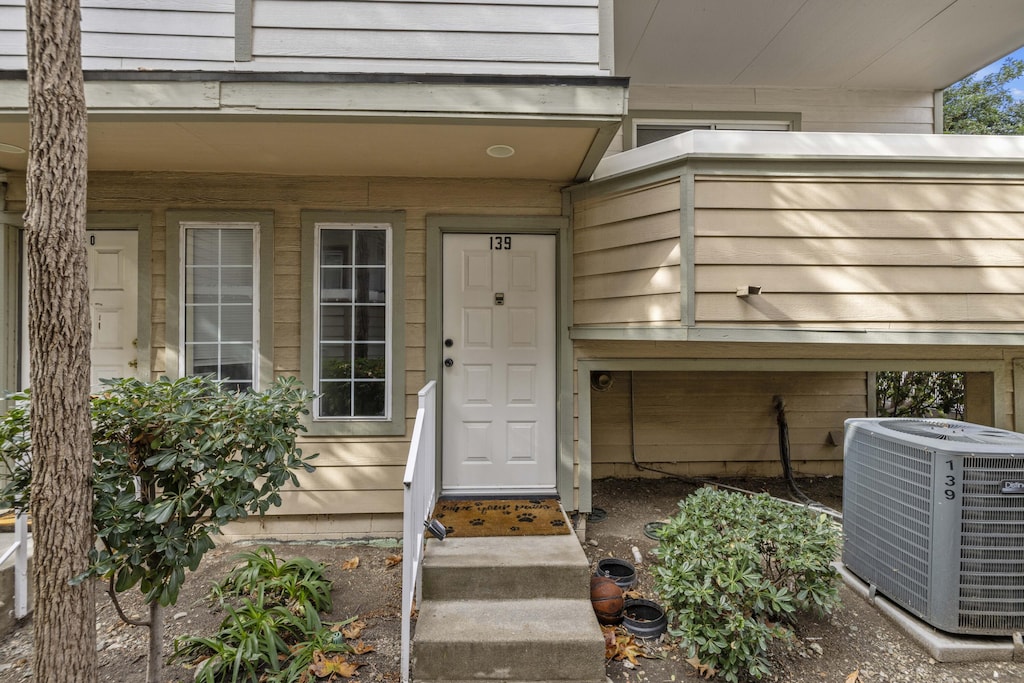 doorway to property featuring cooling unit