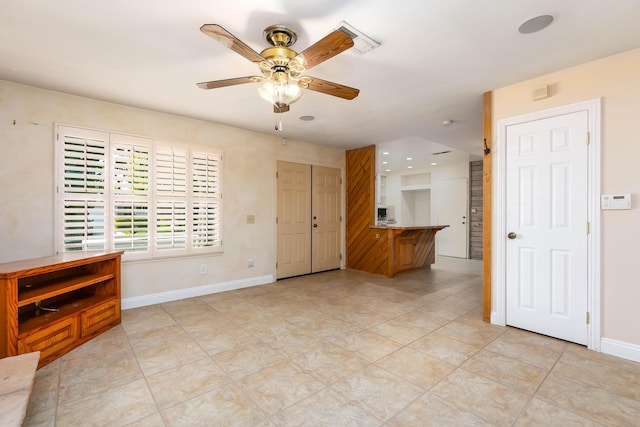 unfurnished living room featuring ceiling fan