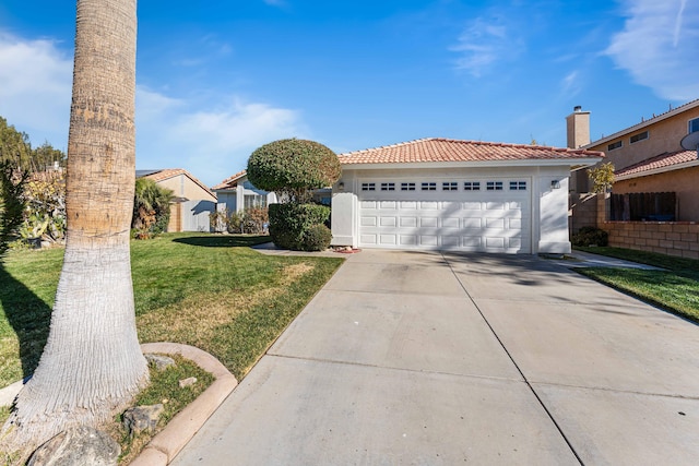 view of front of property featuring a garage and a front lawn