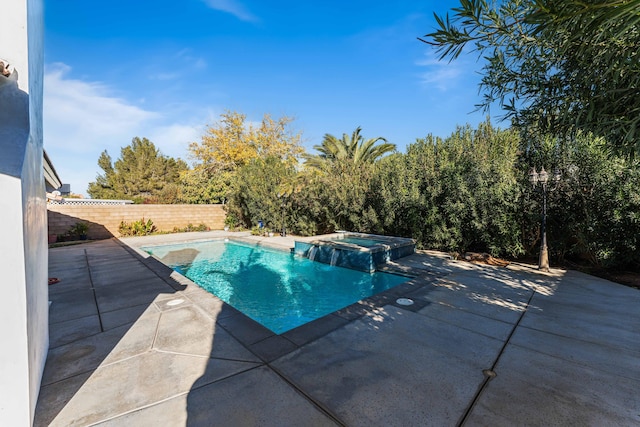 view of swimming pool featuring an in ground hot tub and a patio area