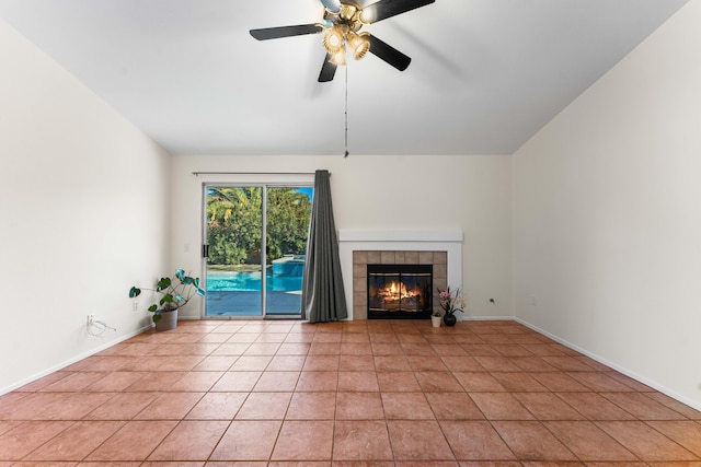 unfurnished living room featuring a tiled fireplace, light tile patterned floors, and ceiling fan