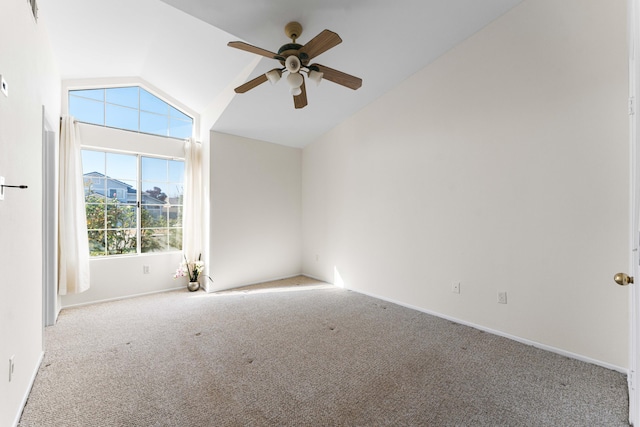 spare room featuring lofted ceiling, light colored carpet, and ceiling fan