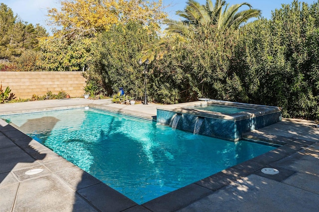 view of swimming pool with an in ground hot tub, pool water feature, and a patio area