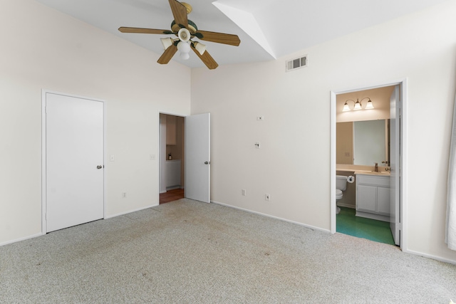 unfurnished bedroom featuring connected bathroom, sink, high vaulted ceiling, light carpet, and ceiling fan