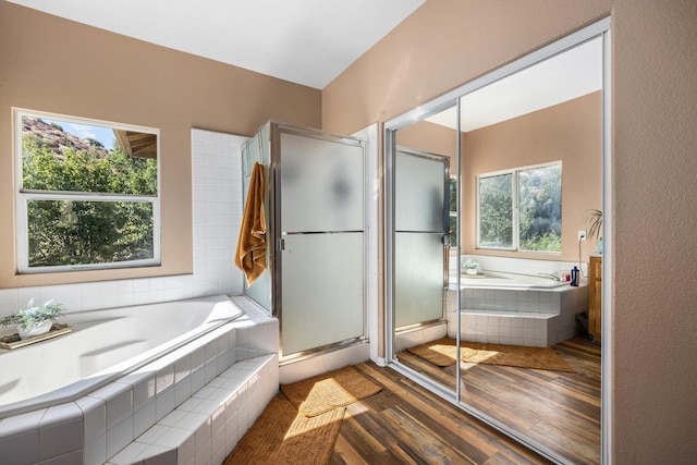 bathroom featuring hardwood / wood-style floors, vanity, and separate shower and tub