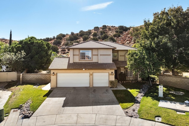 view of front of house featuring a garage and a front lawn