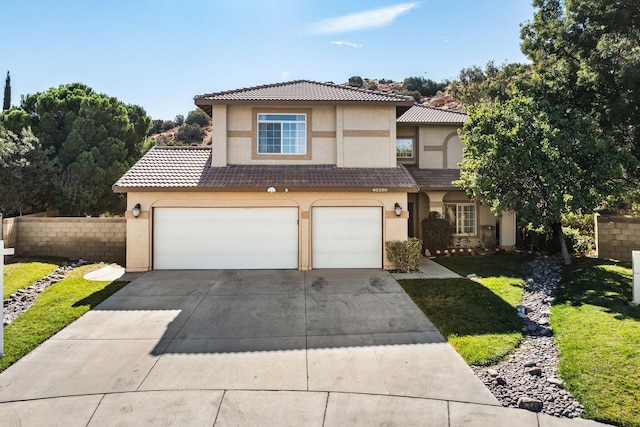 mediterranean / spanish-style house featuring a front yard and a garage