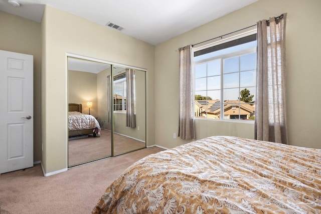 carpeted bedroom with a closet