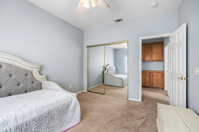 carpeted bedroom with ceiling fan and a closet