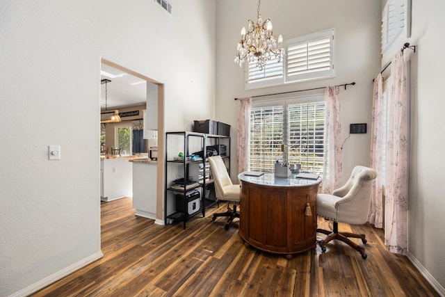 office with a notable chandelier, dark hardwood / wood-style flooring, and a high ceiling