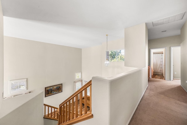 hallway featuring light colored carpet